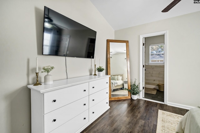 bedroom featuring ceiling fan, vaulted ceiling, dark hardwood / wood-style flooring, and connected bathroom