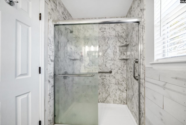 bathroom with a shower with door