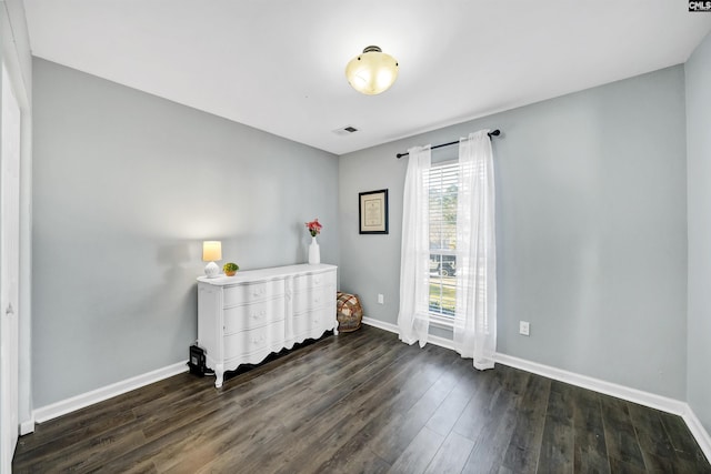 unfurnished bedroom featuring dark hardwood / wood-style flooring