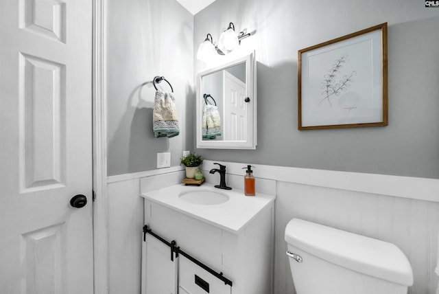 bathroom featuring toilet and vanity