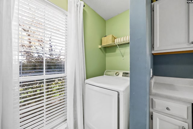 laundry room featuring washer / clothes dryer and a textured ceiling