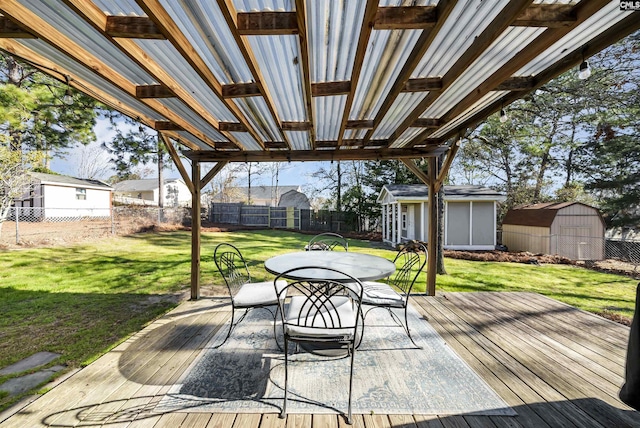 wooden terrace with a yard and a storage unit