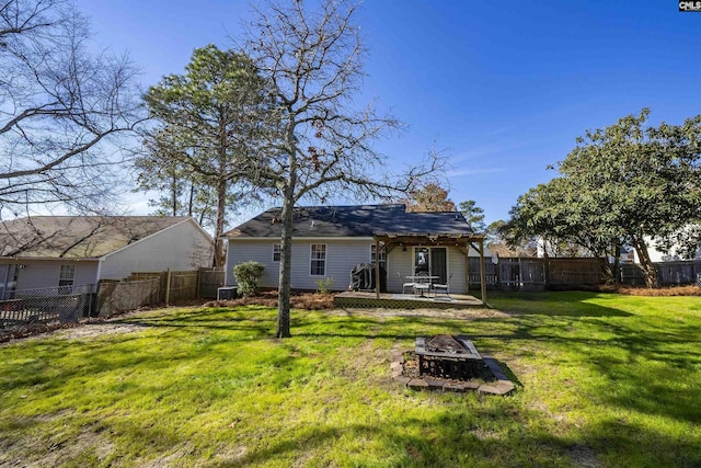 back of house featuring an outdoor fire pit, a lawn, central AC unit, and a pergola