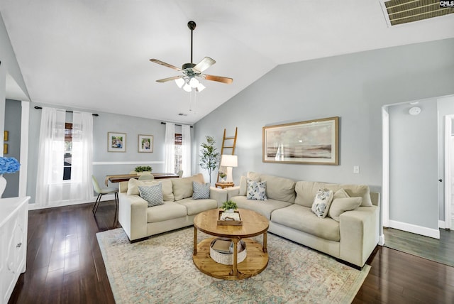 living room featuring plenty of natural light, ceiling fan, and dark hardwood / wood-style floors