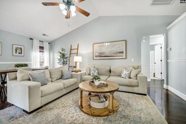 living room with ceiling fan, dark wood-type flooring, and vaulted ceiling