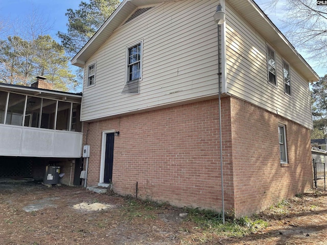 view of side of property featuring a sunroom