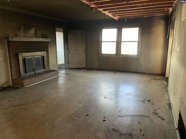 unfurnished living room featuring a brick fireplace