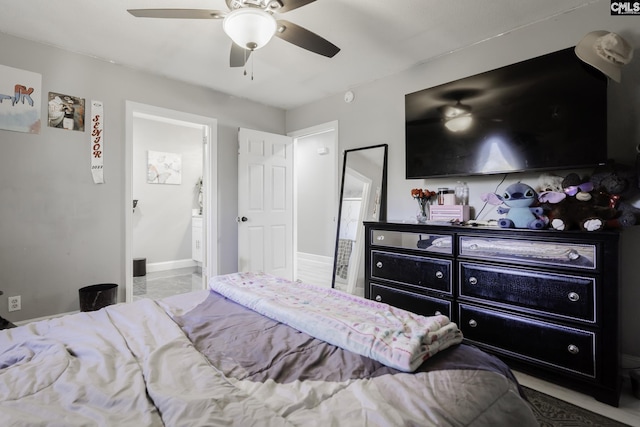 bedroom with ensuite bathroom and ceiling fan