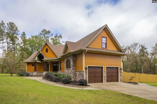 craftsman-style home with a front yard and a garage