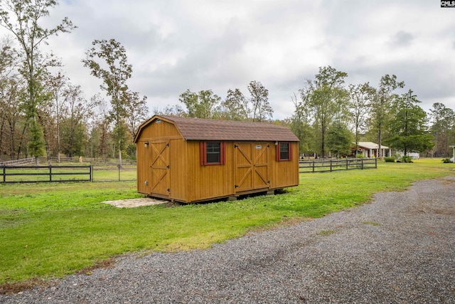 view of outbuilding featuring a yard