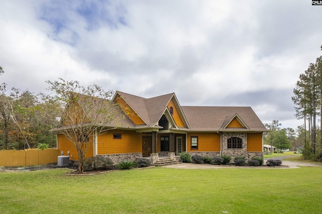 craftsman-style house with a front yard and cooling unit