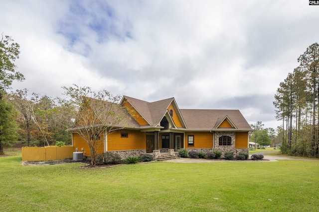 craftsman house featuring central AC unit and a front lawn