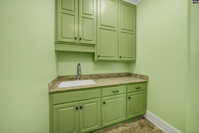 kitchen featuring green cabinets and sink