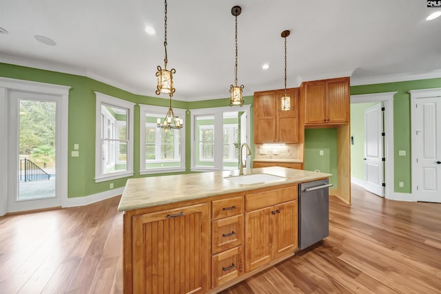 kitchen with sink, dishwasher, hanging light fixtures, a chandelier, and a kitchen island with sink