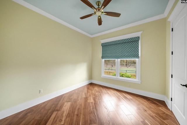 spare room featuring ornamental molding, ceiling fan, and hardwood / wood-style flooring