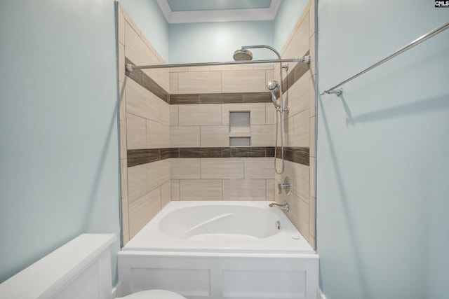 bathroom with toilet and tiled shower / bath