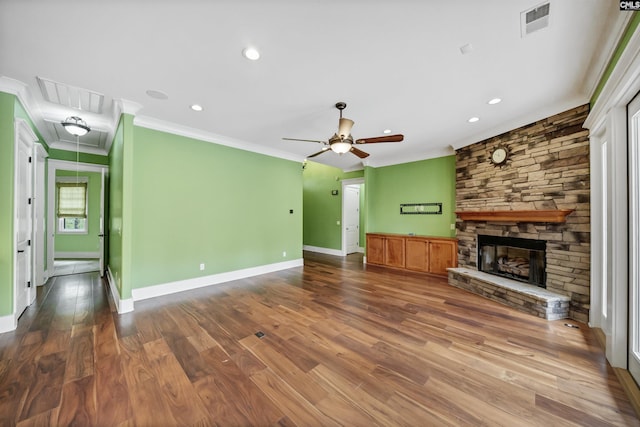 unfurnished living room with hardwood / wood-style floors, a fireplace, ceiling fan, and ornamental molding