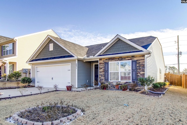 view of front of home featuring a front lawn and a garage