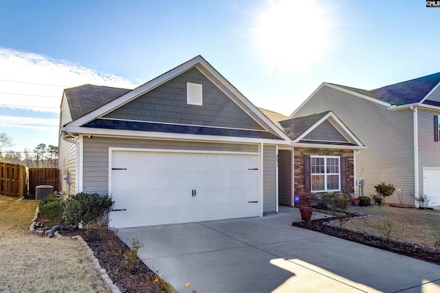 view of front of house featuring a garage and central air condition unit