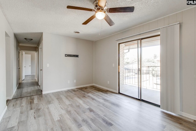 unfurnished room featuring ceiling fan, light hardwood / wood-style floors, and a textured ceiling