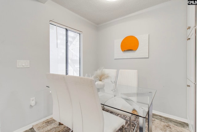 dining area featuring a textured ceiling