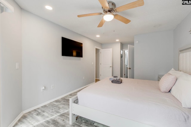 bedroom with ceiling fan and light hardwood / wood-style flooring