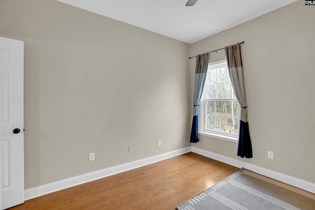 empty room featuring ceiling fan and hardwood / wood-style floors