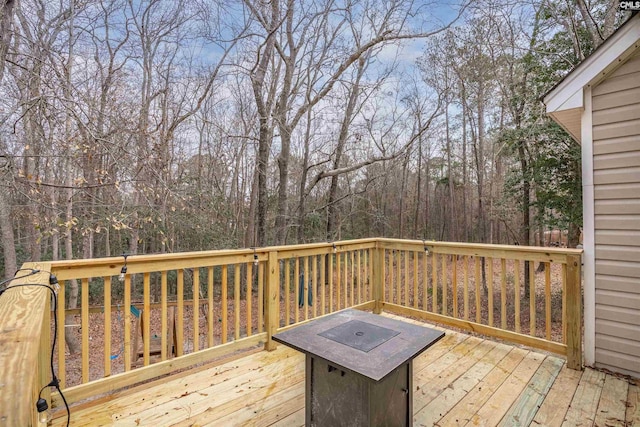 wooden terrace featuring an outdoor fire pit