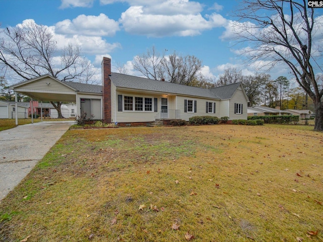 ranch-style home featuring a carport and a front lawn