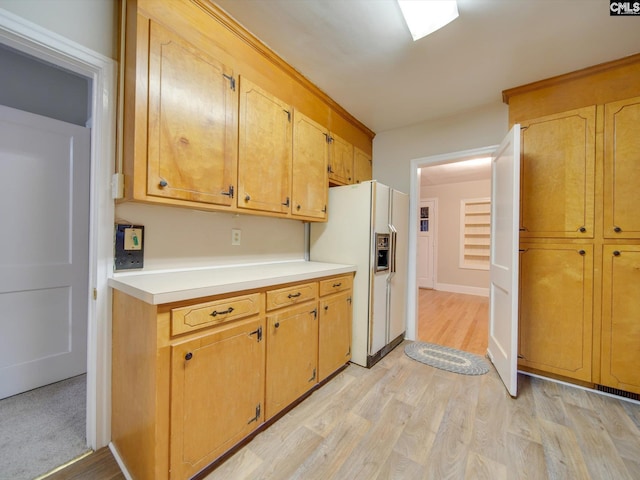 kitchen featuring light hardwood / wood-style flooring and white refrigerator with ice dispenser