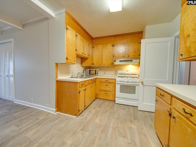 kitchen featuring light wood-type flooring, white gas range oven, and sink