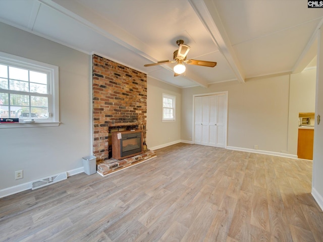 unfurnished living room with ceiling fan, light hardwood / wood-style flooring, plenty of natural light, and a fireplace