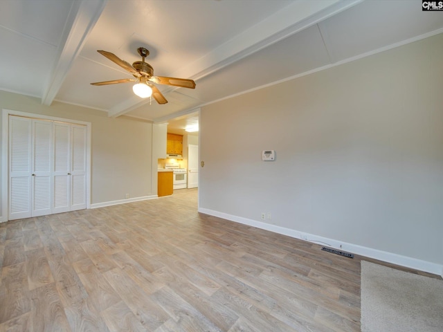 unfurnished room with ceiling fan, light wood-type flooring, ornamental molding, and beamed ceiling