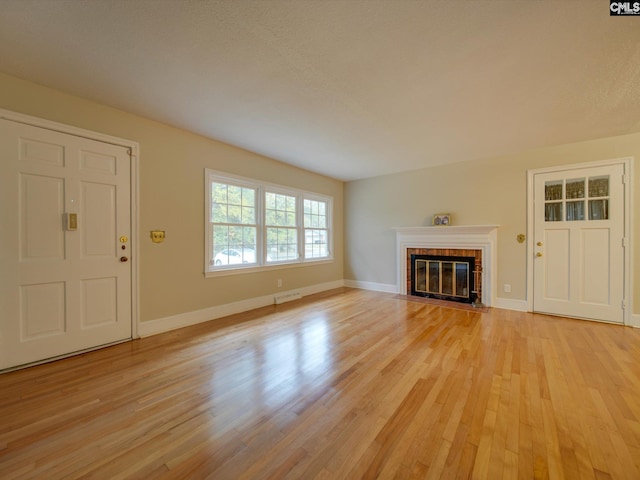 unfurnished living room with light hardwood / wood-style flooring