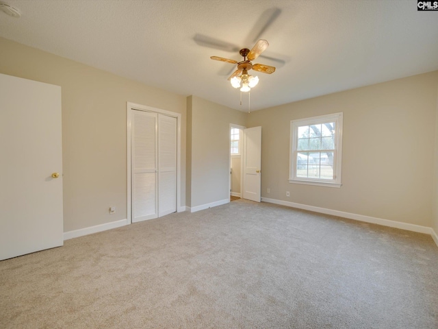 unfurnished bedroom featuring ceiling fan and light colored carpet