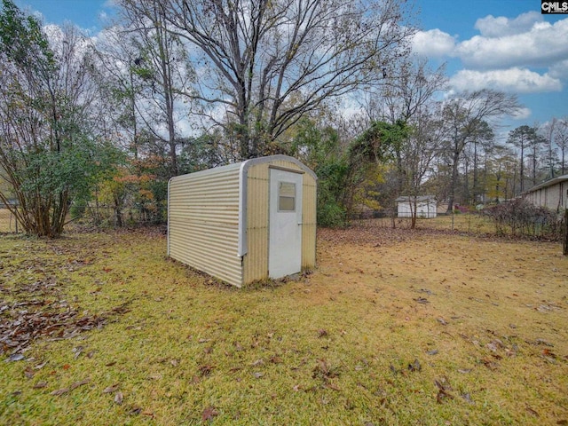 view of outbuilding featuring a lawn