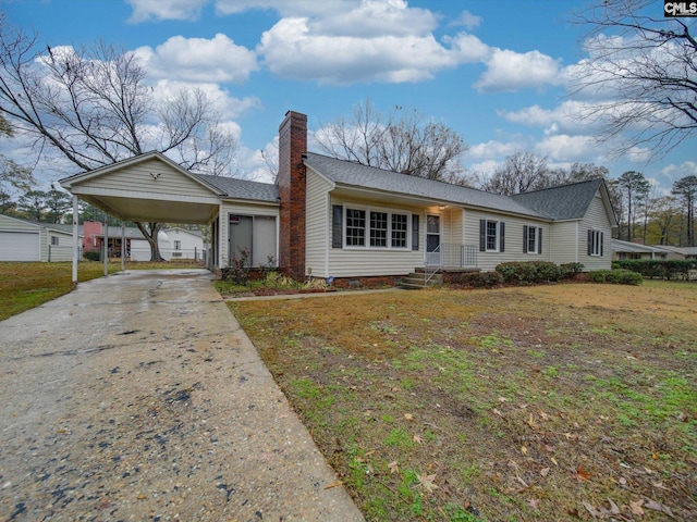 ranch-style home with a carport and a front lawn