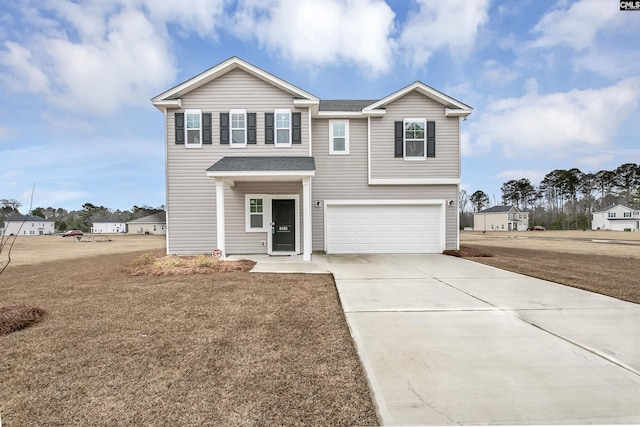 view of front of property featuring a front yard and a garage