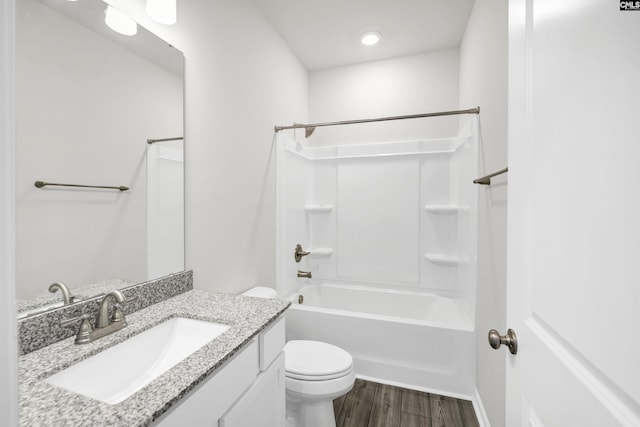 full bathroom with toilet, vanity, hardwood / wood-style floors, and shower / bath combination