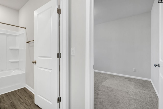 bathroom with shower / bathing tub combination and hardwood / wood-style floors