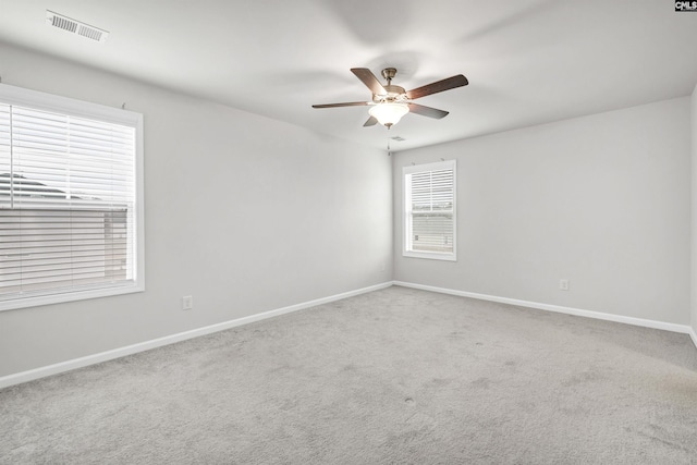 empty room with ceiling fan and carpet floors