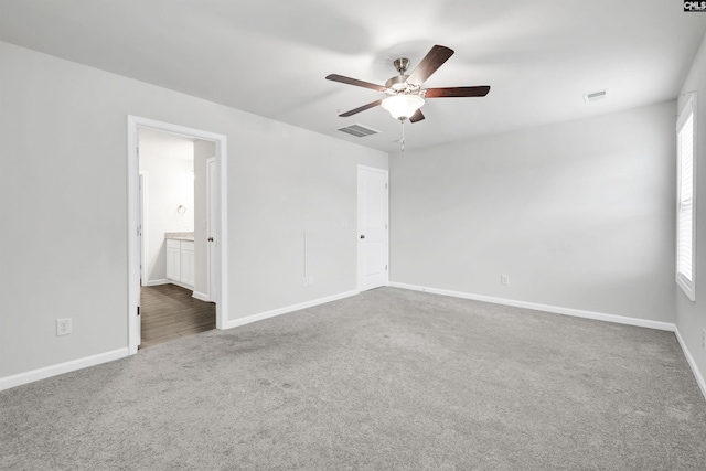 carpeted spare room featuring ceiling fan