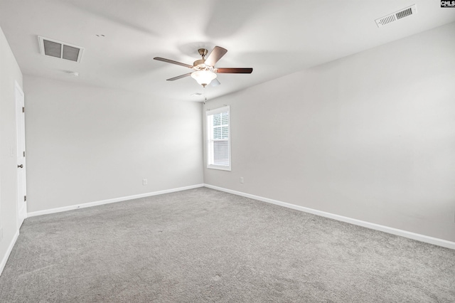 empty room featuring ceiling fan and carpet