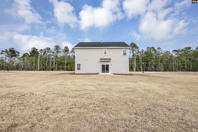 rear view of house with a yard