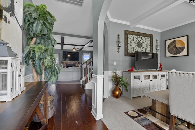 foyer entrance with beam ceiling, dark hardwood / wood-style flooring, and ornamental molding