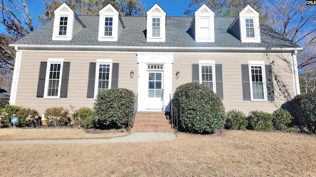 new england style home with a front yard