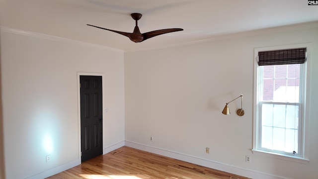 spare room with ceiling fan, a wealth of natural light, light hardwood / wood-style flooring, and ornamental molding