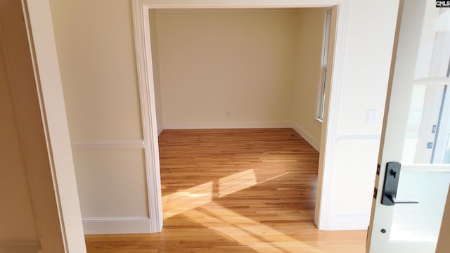 corridor with light wood-type flooring