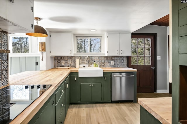 kitchen featuring wooden counters, white cabinetry, green cabinetry, and stainless steel dishwasher