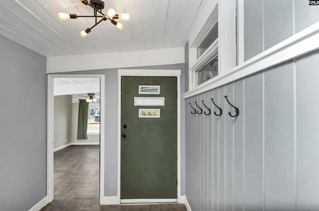 mudroom featuring dark parquet flooring, wood ceiling, and a chandelier